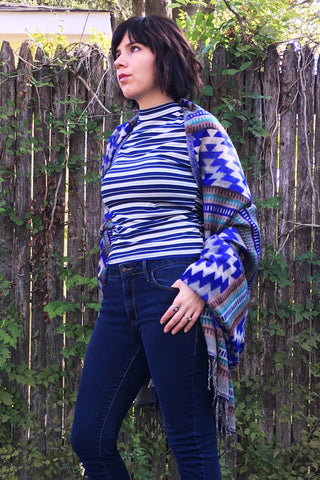 ShopMucho owner models Mexican clothing Southwest style shawl in blue aztec