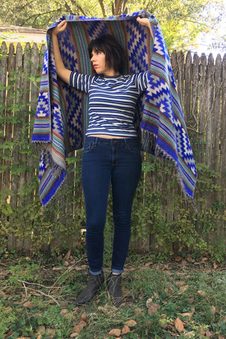 ShopMucho owner models womens accessory Southwest style shawl in blue aztec