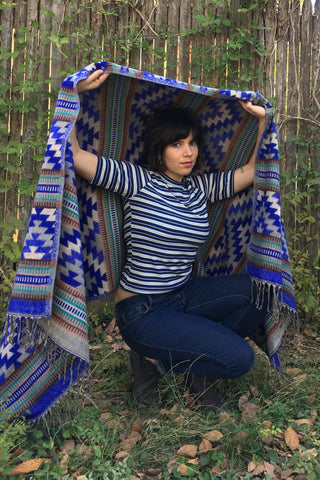 ShopMucho owner models Mexican clothing Southwest style shawl in blue aztec