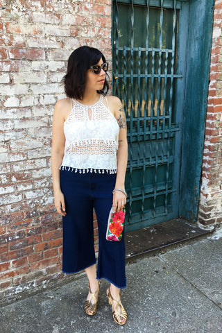 ShopMucho owner style an outfit for a summer evening out downtown in crochet crop top and crop denim frayed denim pants