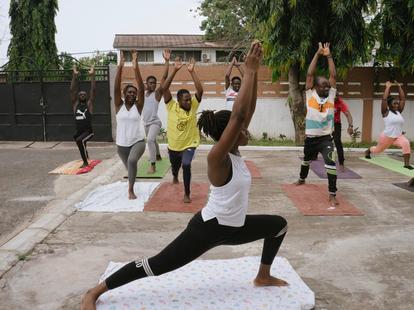 Team members participating in an outdoor yoga class at Accra headquarters.
