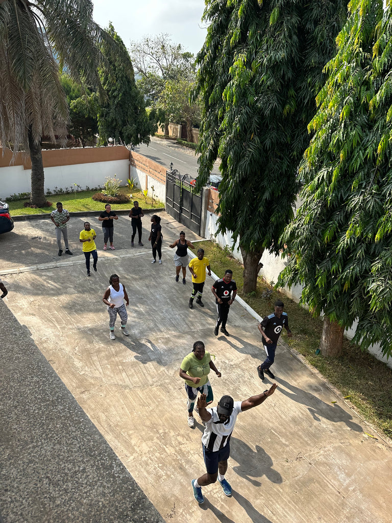 Team members engaging in a fun outdoor activity, fostering learning and growth at Osei-Duro’s Accra headquarters.
