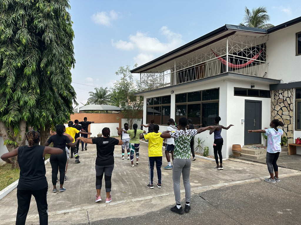 Group fitness session outdoors, fostering team health and collaboration at Osei-Duro’s Accra base.