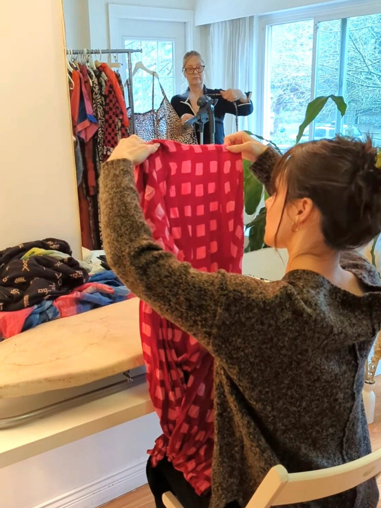 Individual checking a garment for damage, as part of the Reruns program.