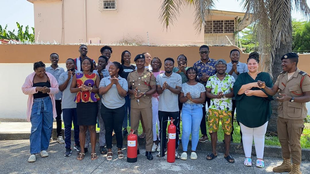 Team members learning fire extinguisher use during a safety training session, enhancing emergency preparedness at Osei-Duro.