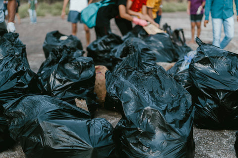 Beach is filled with plastic bags of trash