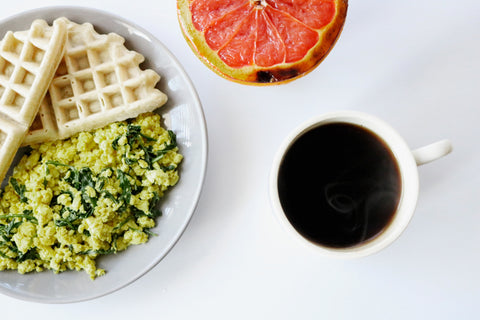 Assorted breakfast foods on a white table