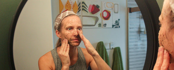 extra coarse green tea facial scrub woman in the mirror