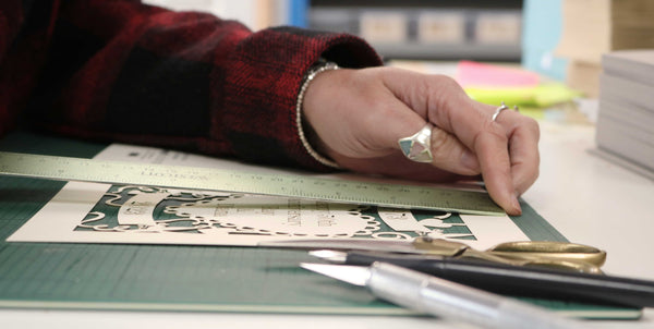 image shows hands measuring a pogofandango laser cut card