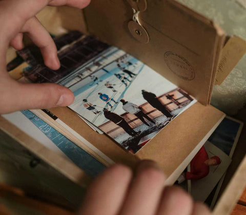 A memory box with greetings cards, postcards and photographs