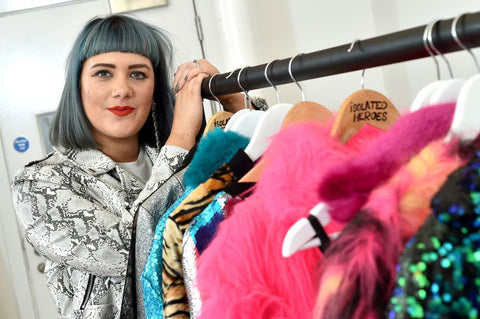 Fashion designer Samantha Paton stands next to the new season rail of Isolated Heroes garments