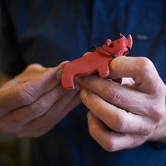 afrographic rhino key ring in hands of artisan