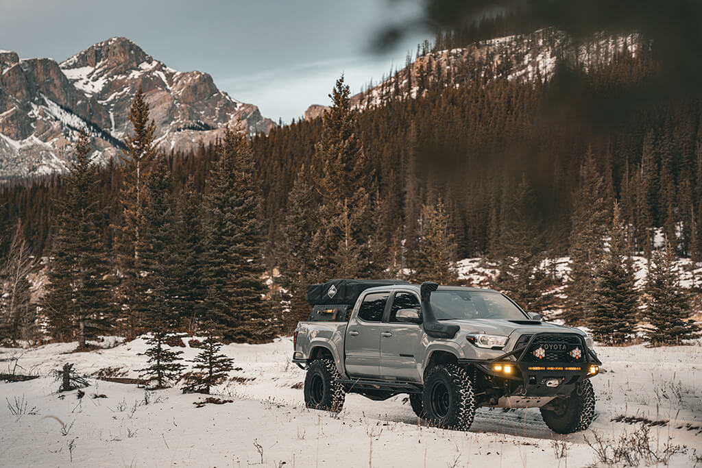 Toyota Tacoma in snowy clearing