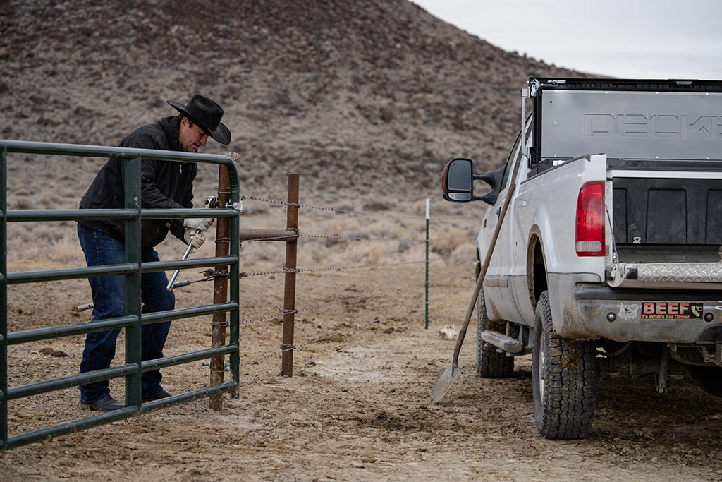 Chaylon Shuffield mends a gate on his family's ranch