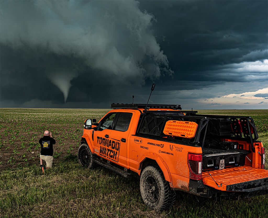 A storm chaser photographs a tornado next to Brutus