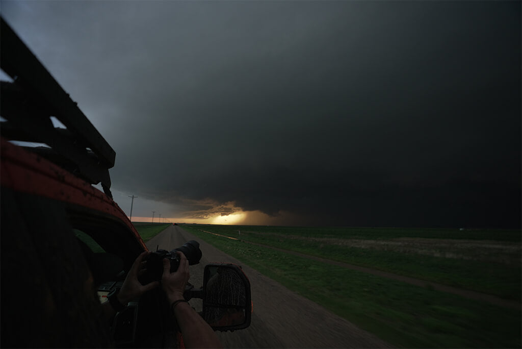 A photographer leans out the passenger window of Brutus