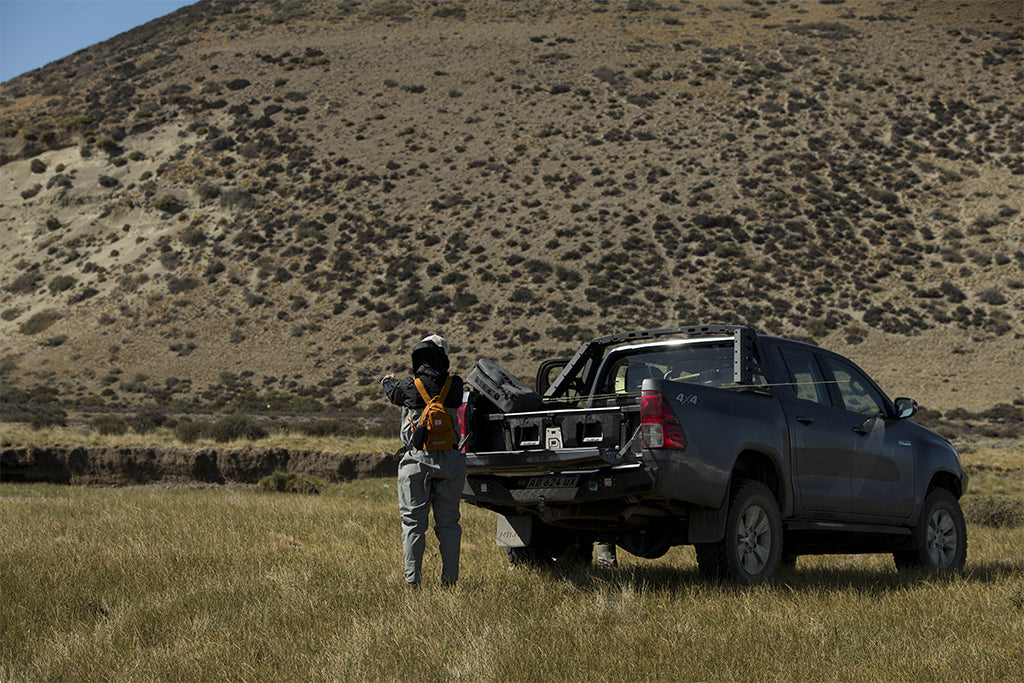 A guide gathers gear from the DECKED Drawer System in his Toyota Hilux