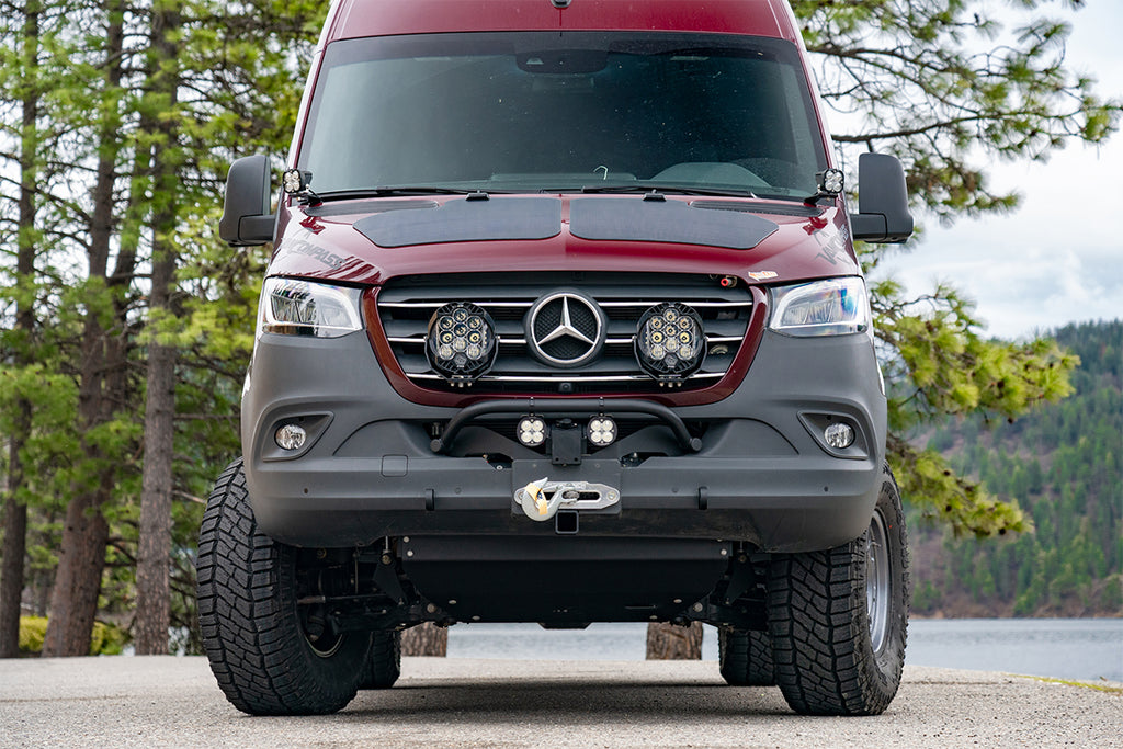 accessories including winch, solar panels, and aux lighting on the front of the van