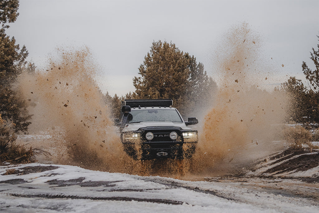 Matt's Ram 2500 Power Wagon blasts through a muddy, snowy puddle
