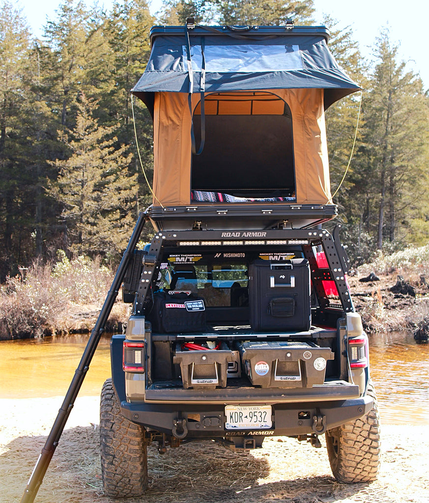 Rear shot of a Gladiator with rooftop tent, Drawer System, and Dometic fridge