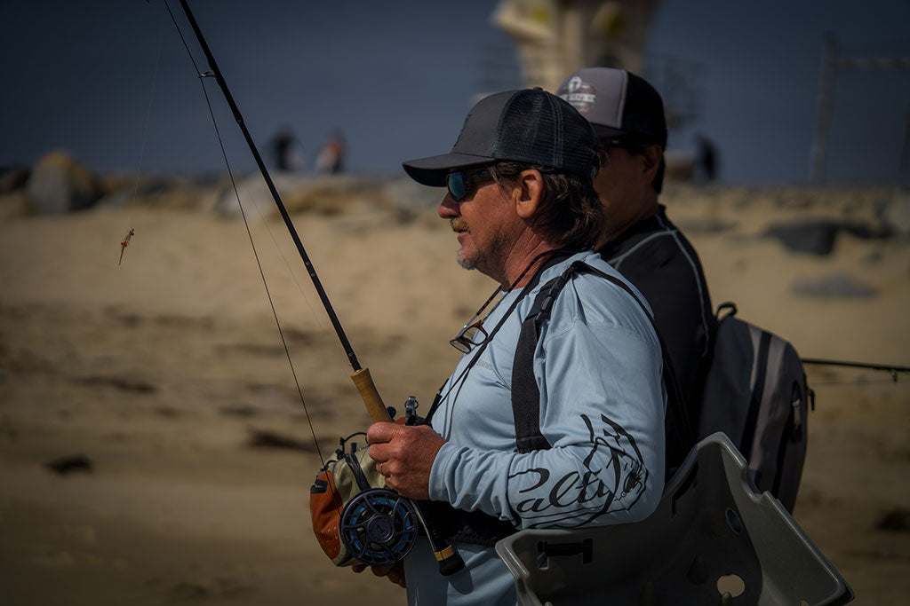 Vaughn stands onshore and gazes at the ocean