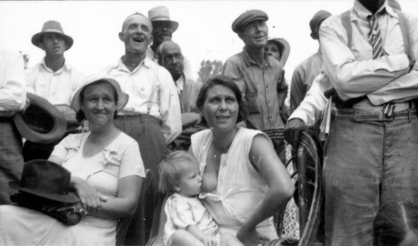 Black and white family photo with mother breastfeeding child