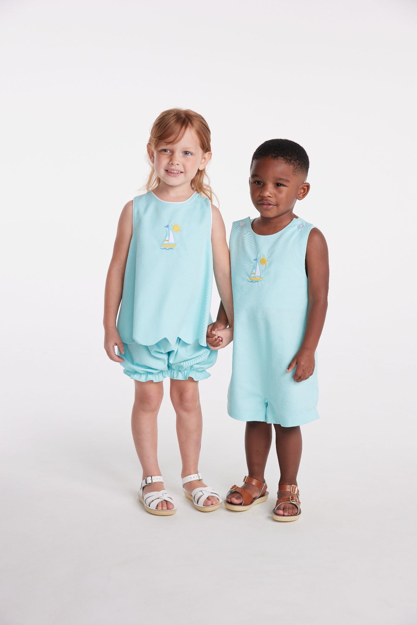 classic childrens clothing girls bloomer set in aqua with bow in the back and applique sailboat on chest