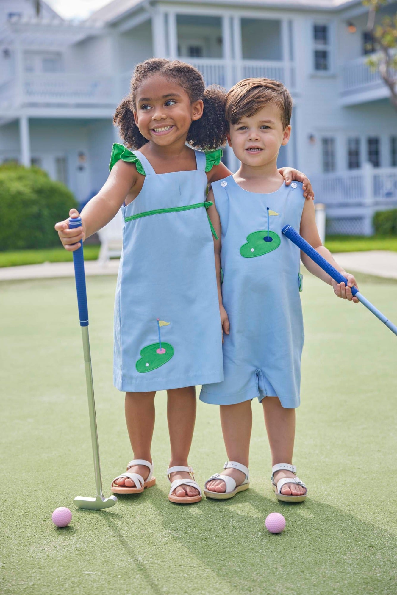 classic childrens clothing girls blue dress with green ruffle sleeves and applique golf