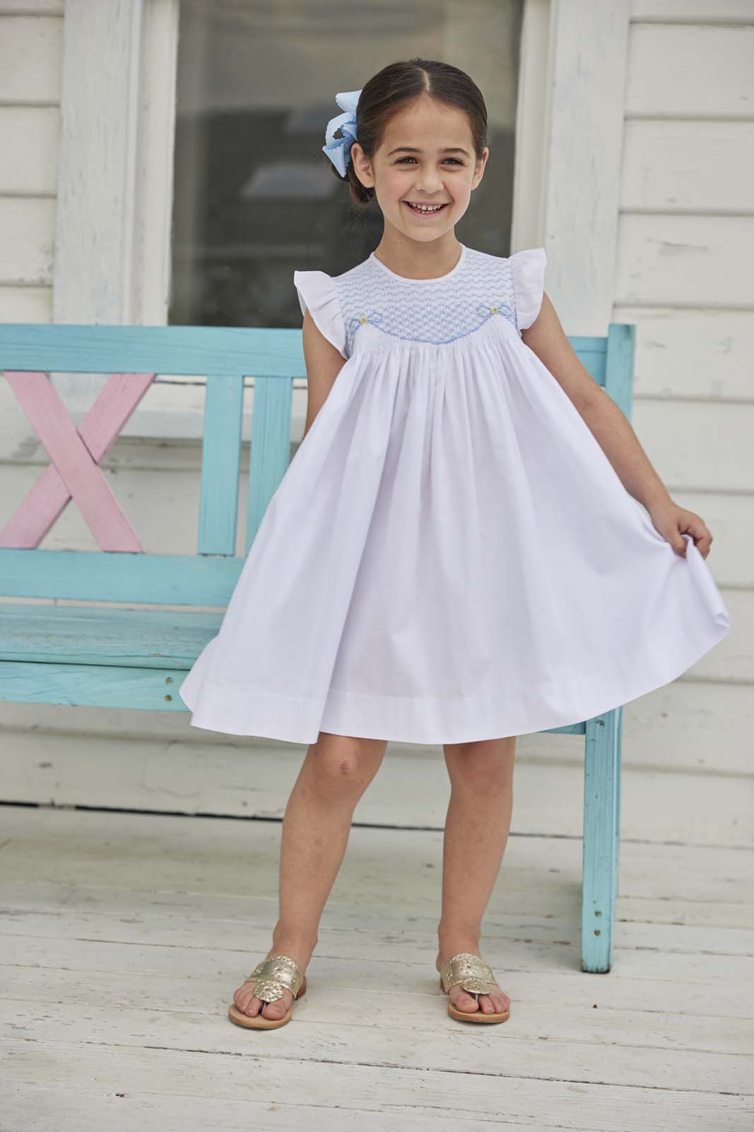 classic childrens clothing girls white dress with ruffle sleeves and blue smocking