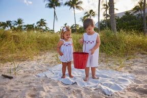 classic childrens clothing boys shortall in light blue with smocking detail and embroidered crabs