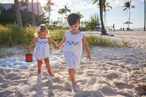 classic childrens clothing boys shortall in light blue with smocking detail and embroidered crabs