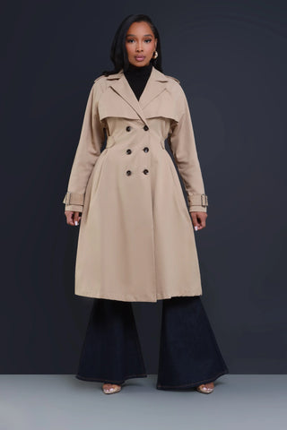 Swank girl wearing a buttoned trench coat