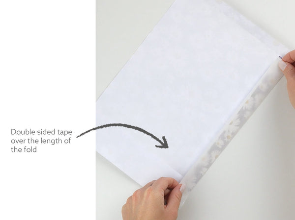 use the double sided tape over the length of the fold