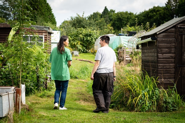 two people talking in a garden