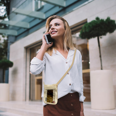 Female on the phone with a passport holder around her torso