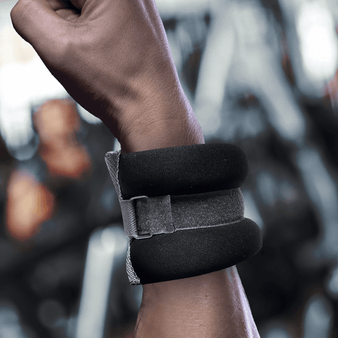 Picture of an athletes arm with a weight wrapped around their wrist