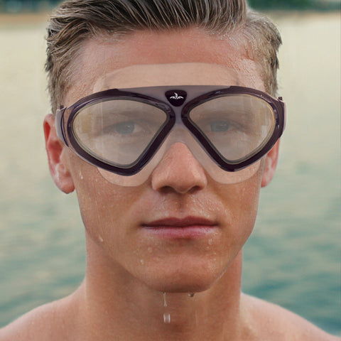Photo of a male swimmer wearing a black pair of swimming goggles