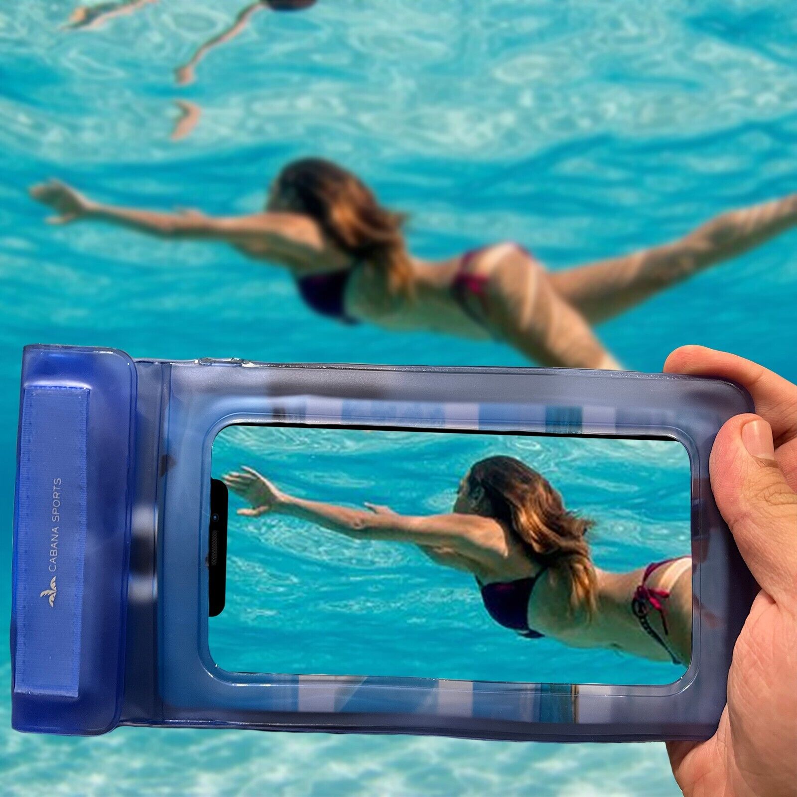 Swimmer recording a video underwater with a phone inside a waterproof pouch