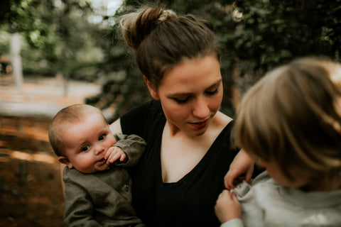 Busy mom with 2 children showing patience