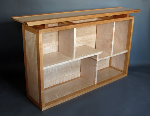 This solid wood bookcase and display cabinet was a custom furniture order for displaying a special art book collection.