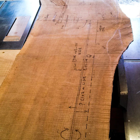 Careful layout planning on a wood slab at Mokuzai Furniture.