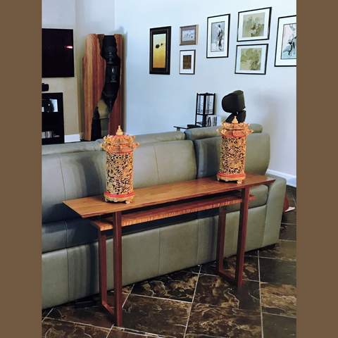 A low sofa console table made from walnut wood.  A custom furniture design by Mokuzai Furniture.