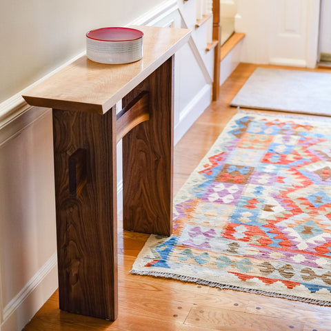 a narrow hall table in a modern entryway by Mokuzai Furniture