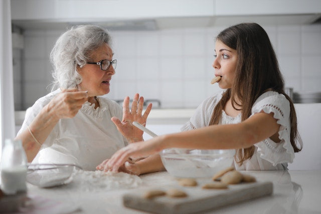 A grandma and a granddaughter eating
