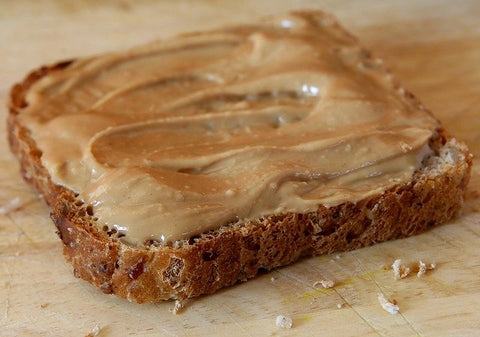 A slice of bread with peanut butter.