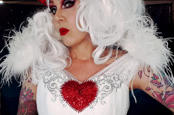 Rockstars and Royalty drag inspired goth alternative makeup over 40 white wig winged heart dress