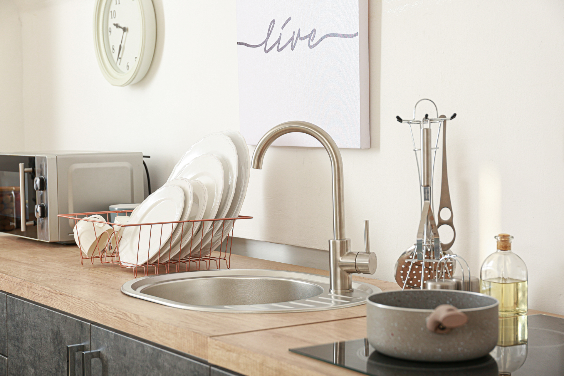 Single bowl sink with clean dishes on the side