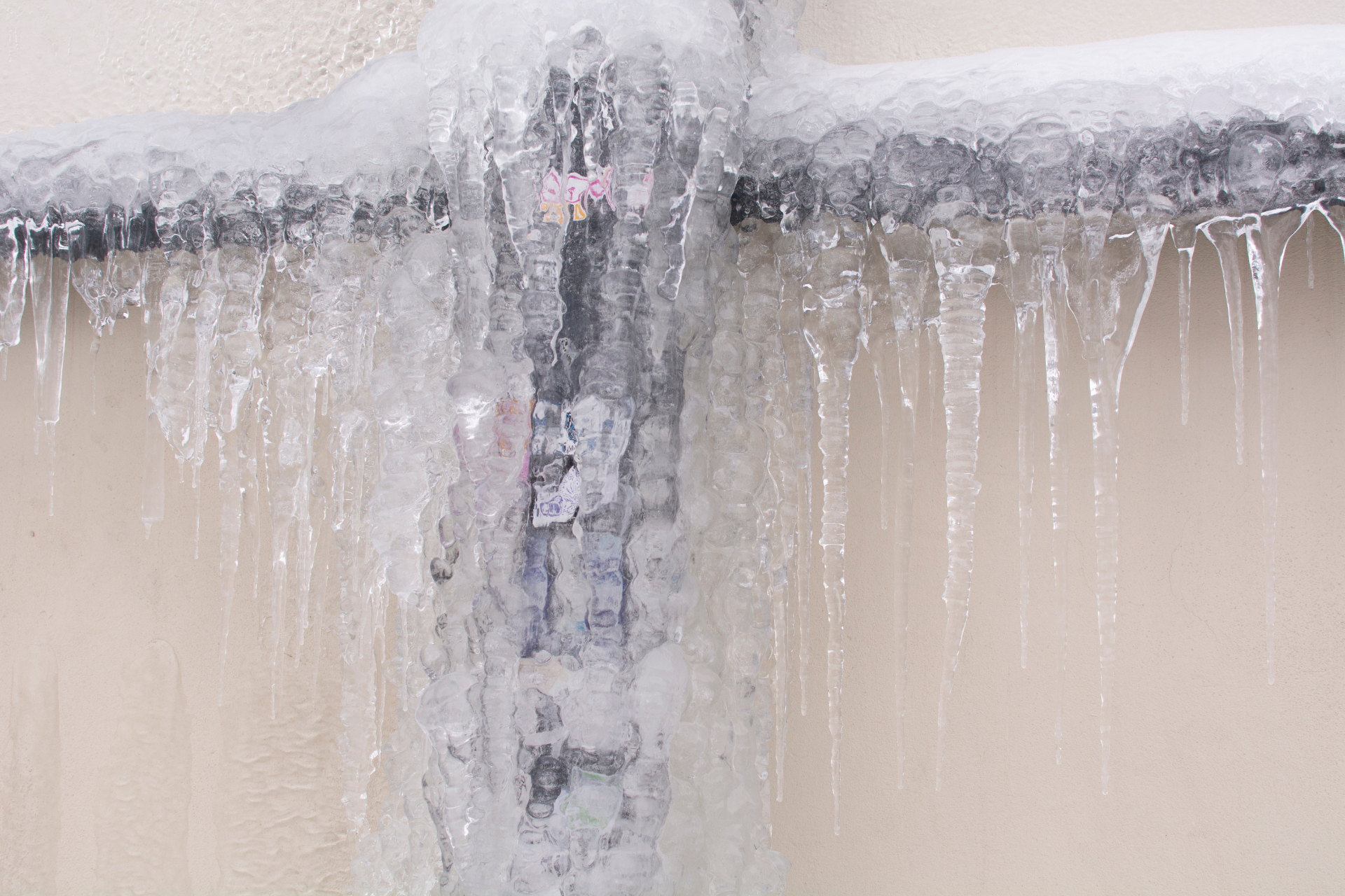 A frozen water pipe covered in icicles