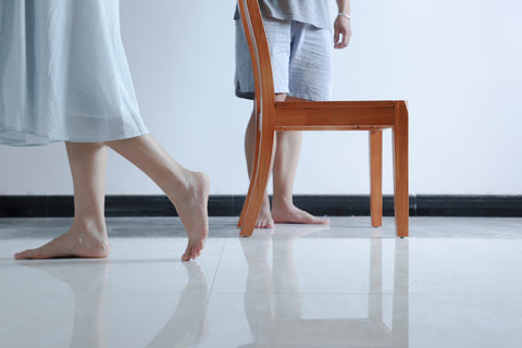People standing barefoot at home. Photo from pexels.com