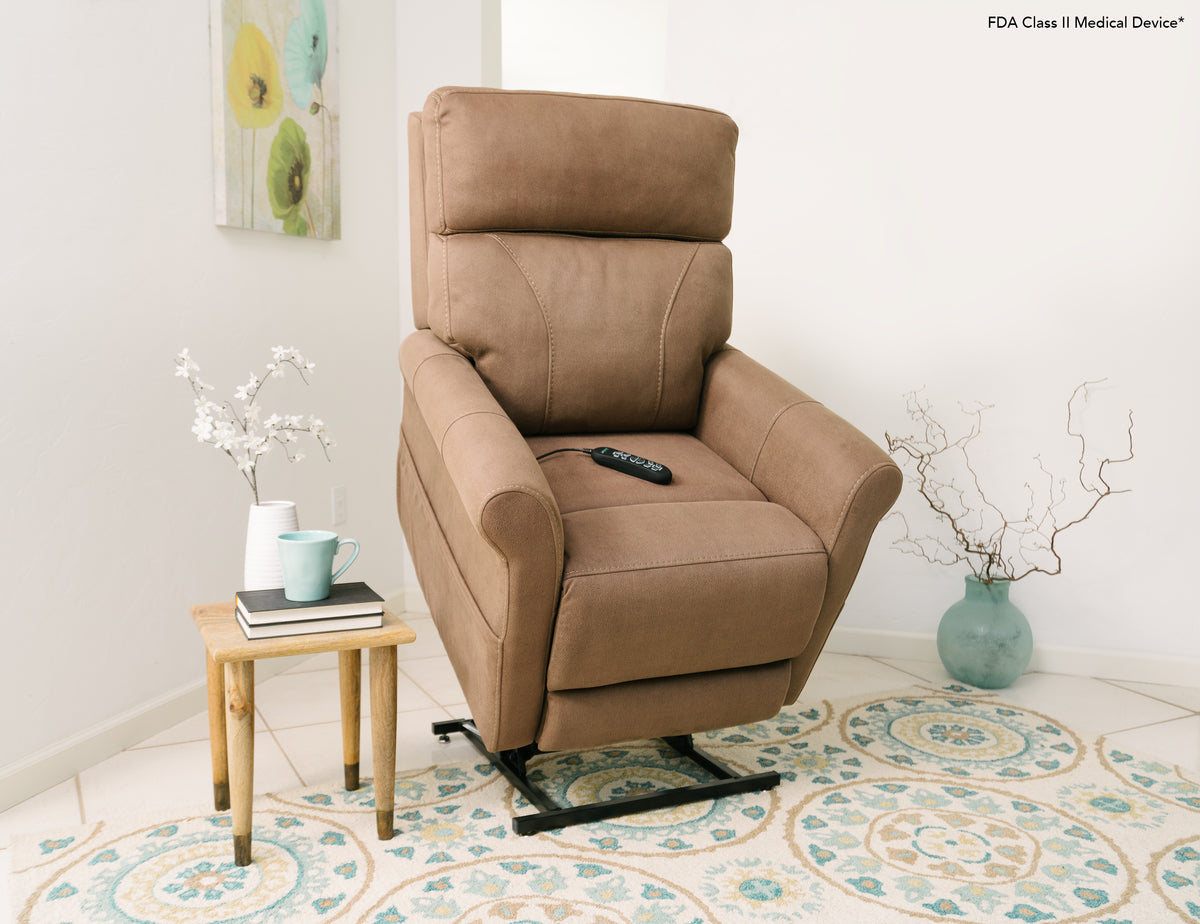 a beige lift chair is viewed at in angle in the raised position in a white room with some pale blue and green decor and a small side table